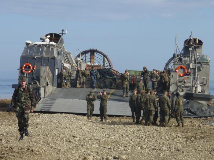 Landing Craft Air Cushion (LCAC) transporting U.S. Public Health Service officers and relief supplies from USS Bataan to a Haitian…